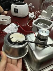 Comparison of a ceramic disc in a household ultrasonic cleaner and a metal transducer in a commercial ultrasonic cleaner