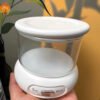 Portable ultrasonic retainer cleaner with open lid and transparent glass tank